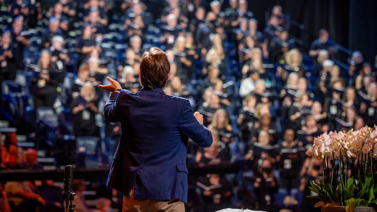 Conductor leading a choir in worship
